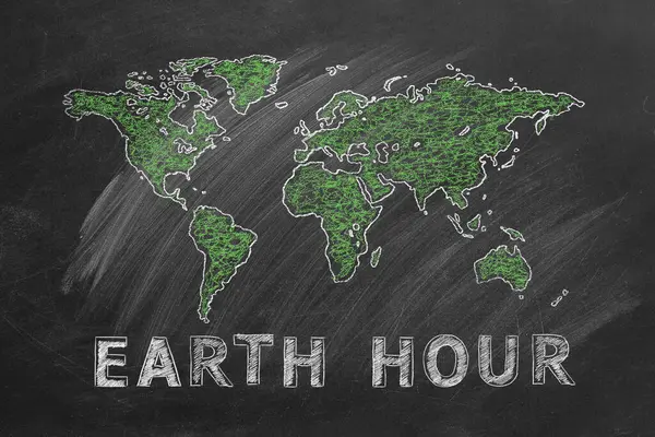 World map with lettering EARTH HOUR hand drawn in chalk on a school blackboard. Save the World. Save our planet.