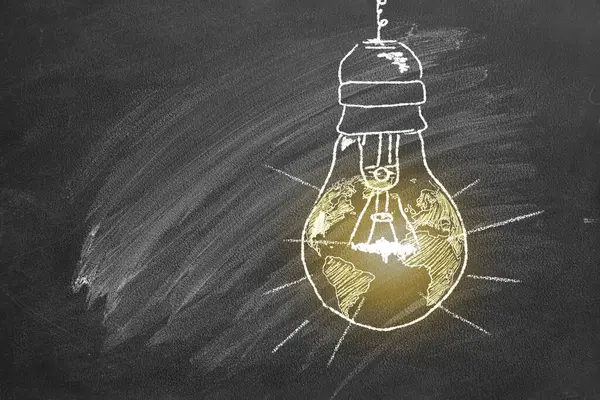 A light bulb with a globe inside, drawn in chalk on a school board. Earth hour concept. Save the world. Save our planet.