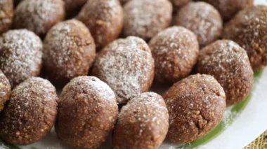 chocolate sweet cakes from mashed biscuits with additives, in a plate on a wooden table.