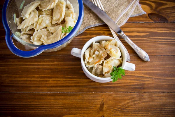 Cooked Dumplings Potatoes Fried Onions Bowl Wooden Table — Zdjęcie stockowe