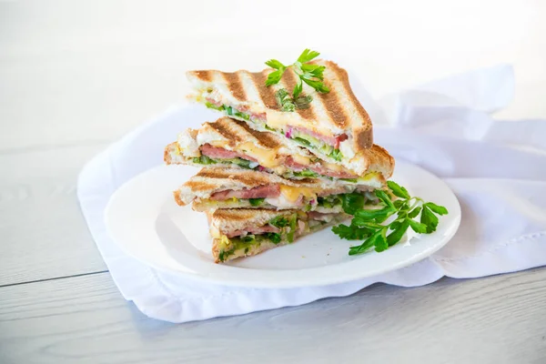 stock image fried toasts stuffed with sausage, cheese and greens inside, in a bowl on the table..