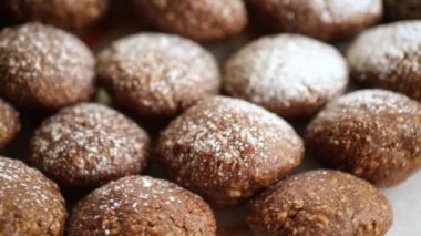 chocolate sweet cakes from mashed biscuits with additives, in a plate on a wooden table.