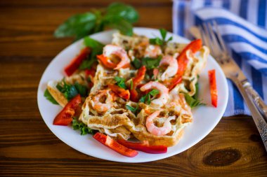 Tahta bir masada karides ve sebzeli sade omlet..