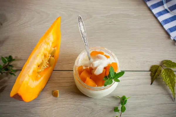 Homemade yogurt with pieces of pumpkin marmalade. Autumn recipes.