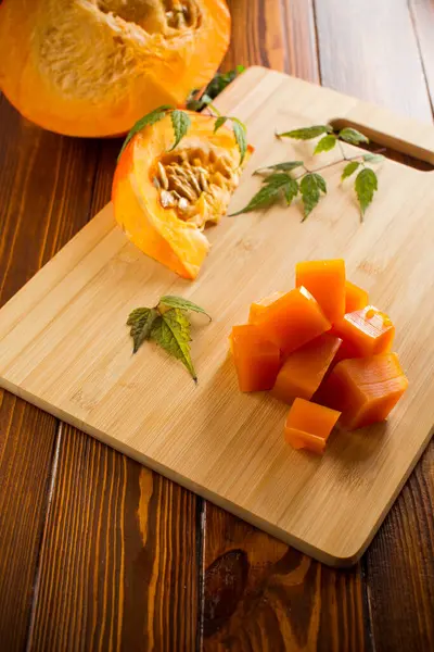 Prepared sweet pumpkin marmalade on a wooden table. Autumn recipes.