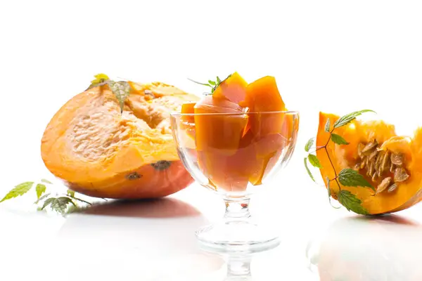 Prepared sweet pumpkin marmalade in a glass bowl isolated on a white background. Autumn recipes.