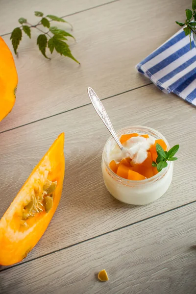 Homemade yogurt with pieces of pumpkin marmalade. Autumn recipes.