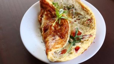 Ahşap bir masada tabakta çeşitli sonbahar sebzeleriyle kızartılmış omlet. Sonbahar tarifleri.