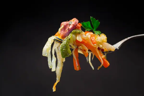 검은색 배경에 포크에 야채와 소시지와 양배추를 — 스톡 사진