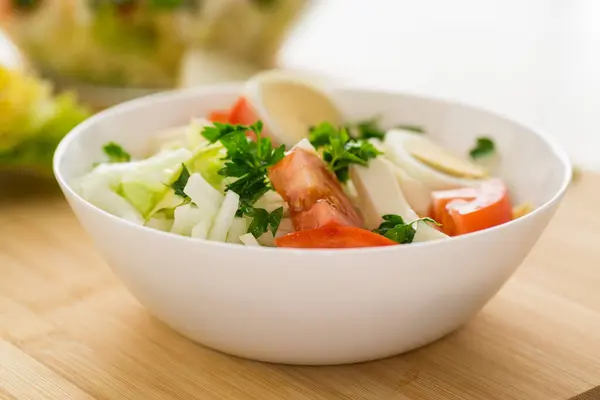新鮮な野菜サラダ キャベツ 木製のテーブルのボウルにトマト ストック画像