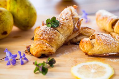 Tatlı hamur işleri, armutlu börekler, ahşap bir masada. .
