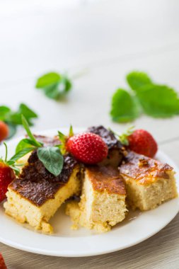 prepared cottage cheese casserole with fresh strawberries .