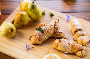 Tatlı hamur işleri, armutlu börekler, ahşap bir masada. .