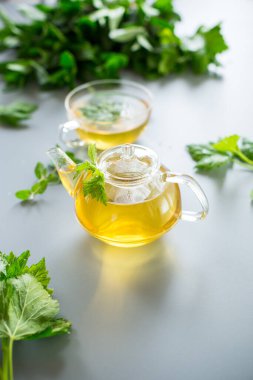 Frenk üzümü yapraklarından yeşil çay ve cam bir kapta nane..