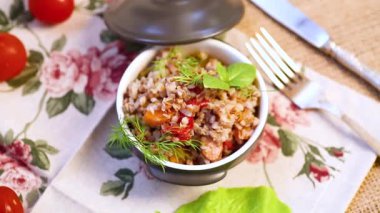 Tahta bir masada seramik kasede sebzeli haşlanmış karabuğday..