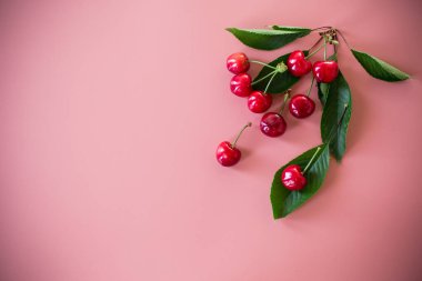 Pembe arkaplanda kirazlar ve yan tarafında boşluk.