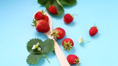 Yukarıdan mavi arka planda olgun kırmızı çilekler..