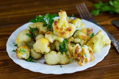 Karanlık bir mutfak yüzeyinde iştah açıcı kızarmış karnabahar..