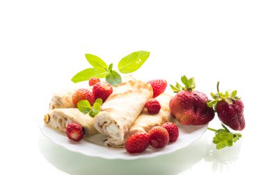 Beyaz arka planda süzme peynirli ve çilekli krepler..