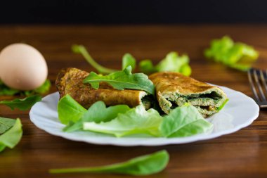 Ev yapımı omlet, salata ve yeşil yapraklı..