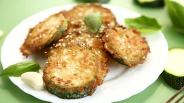 Beyaz bir tabakta susamlı gevrek kabak dilimleri..