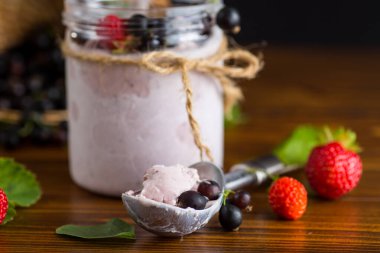 Çilekli soğuk tatlı ve ahşap arka planda kuşüzümü..