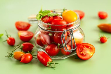 Cam kavanozda fesleğen yapraklı kiraz domatesleri..