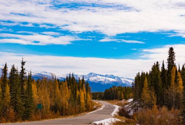 First snow in late fall or early winter at northern section of scenic route of Stewart-Cassair-Highway 37 in Northern British Coumbia mountain landscape, BC, Canada clipart