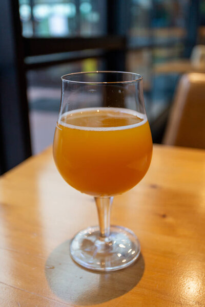 orange juice in a glass on a wooden table