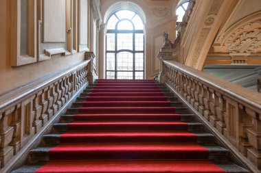 Turin, Italy - January 2023: Palazzo Barolo staircase. Luxury palace with old baroque interior and red carpet