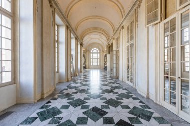Venaria Reale, Italy - January 2023: luxury interior old royal palace. Gallery perspective with window