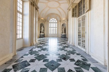 Venaria Reale, Italy - January 2023: luxury interior old royal palace. Gallery perspective with window