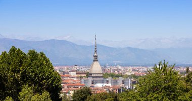 Turin - Italy - Urban skyline with Mole Antonelliana building, blue sky and Alps mountains