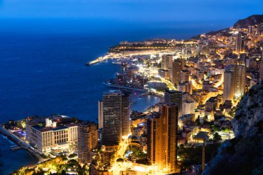 Monte Carlo panoraması gece aydınlandı. Lüks mimarisi olan şehir manzarası