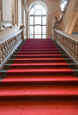 Turin, Italy - January 2023: Palazzo Barolo staircase. Luxury palace with old baroque interior and red carpet