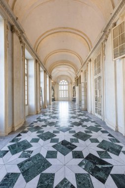 Venaria Reale, Italy - January 2023: luxury interior old royal palace. Gallery perspective with window