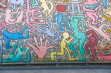 Pisa, Italy - 29 June 2023: Tuttomondo (All World) is the last mural created by American artist Keith Haring in 1989 before his death. clipart