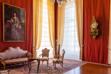 Venaria Reale, Italy - February 2023: luxury interior, old Royal Palace. Perspective with harp, window and baroque decoration.