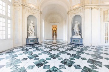 Venaria Reale, Italy - January 2023: luxury interior old royal palace. Gallery perspective with window