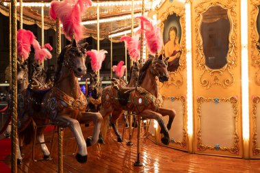 Florence, Italy - 30 April 2024. Carousel horses. Antique merry-go-round, vintage nostalgia concept clipart