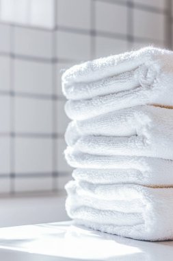 Parlak bir banyoda düzgünce katlanmış, taze, beyaz havlular.