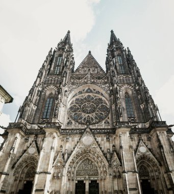 Low-angle view of the gothic facade of St. Vitus Cathedral within the Prague Castle complex in the Czech Republic. clipart