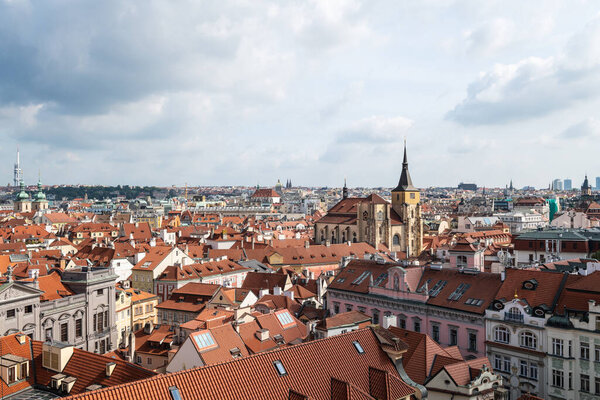 Aerial panoramic view of Prague against a cloudy sky.