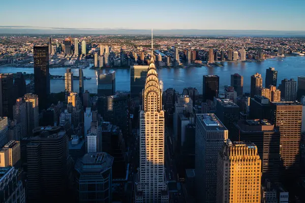stock image Aerial view of the iconic Chrysler Building and other Manhattan skyscrapers at dusk, New York City. This breathtaking scene captures the city lights and the timeless elegance of New York's architectural landmarks, highlighting the vibrant energy and 