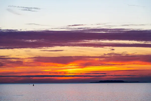 stock image Silhouette of the Galician coast at the opening of the Ria de Pontevedra and the Ria de Arousa at dusk, were the Atlantic ocean meets the land.