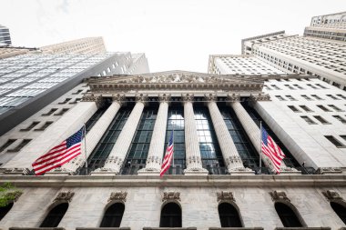 Manhattan, New York 'taki Wall Street' teki ikonik New York Borsası binasının alçak açılı görüntüsü.