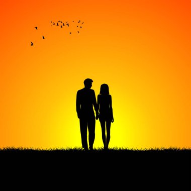Gün doğumunda birbirine aşık bir çiftin siluetleri.