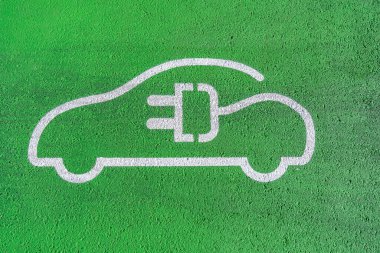 Elektrikli arabalara ayrılmış özel bir park yeri. Araba şarj aleti.