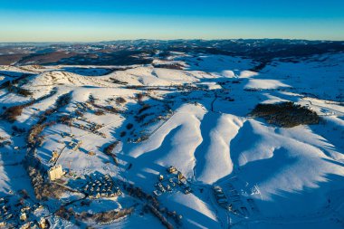 Panoramic aerial view of Zlatibor town and low cloud over Zlatibor Mountain at winter sunset, Cajetina, Serbia. clipart