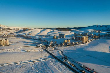 New buildings and urbanisation of Zlatibor mountain.Panoramic aerial view of Zlatibor town and clear sky over Zlatibor Mountain at winter sunset, Cajetina, Serbia. clipart